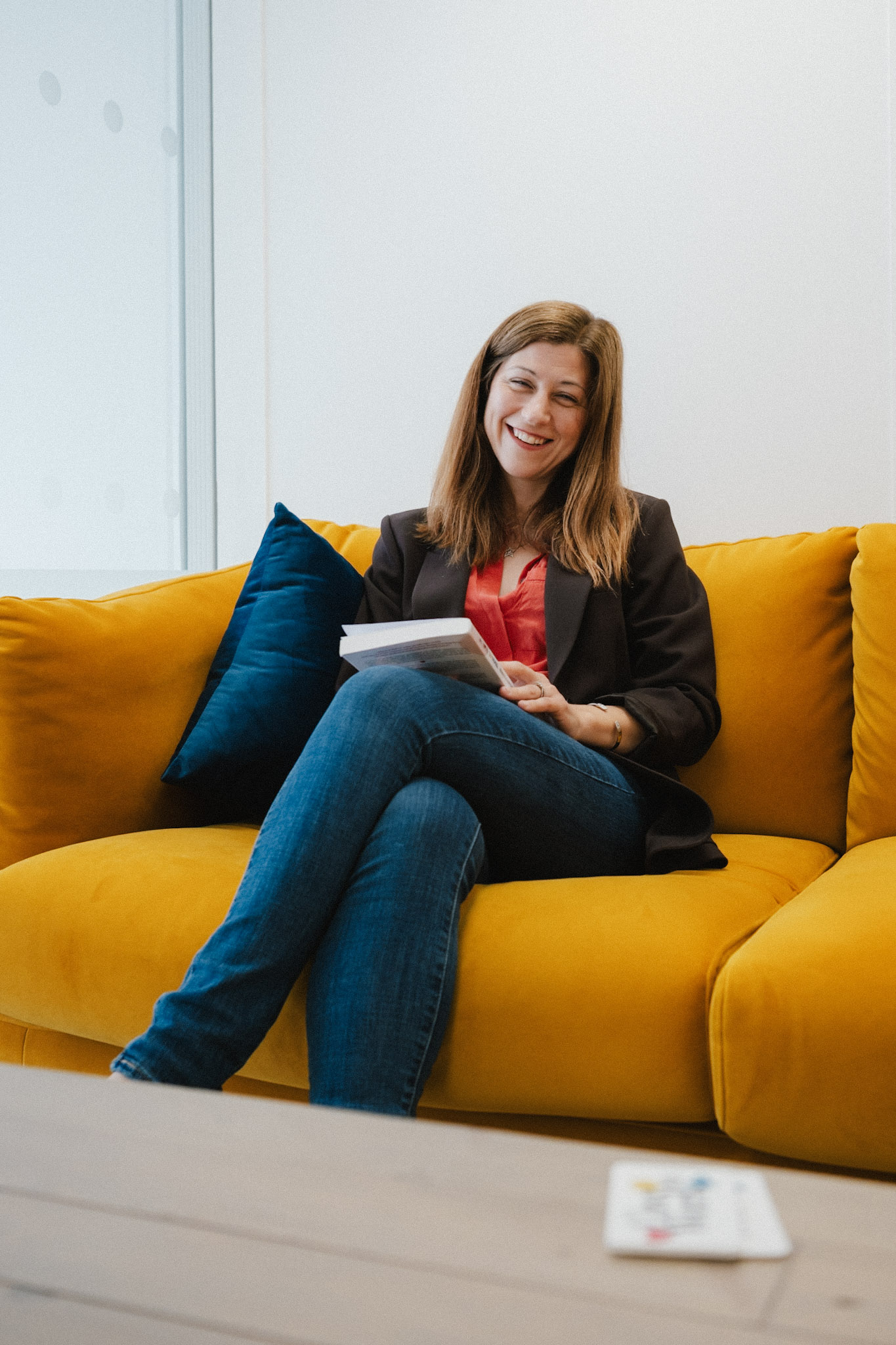 Rebecca Longman holding a copy of Let's Love To Work