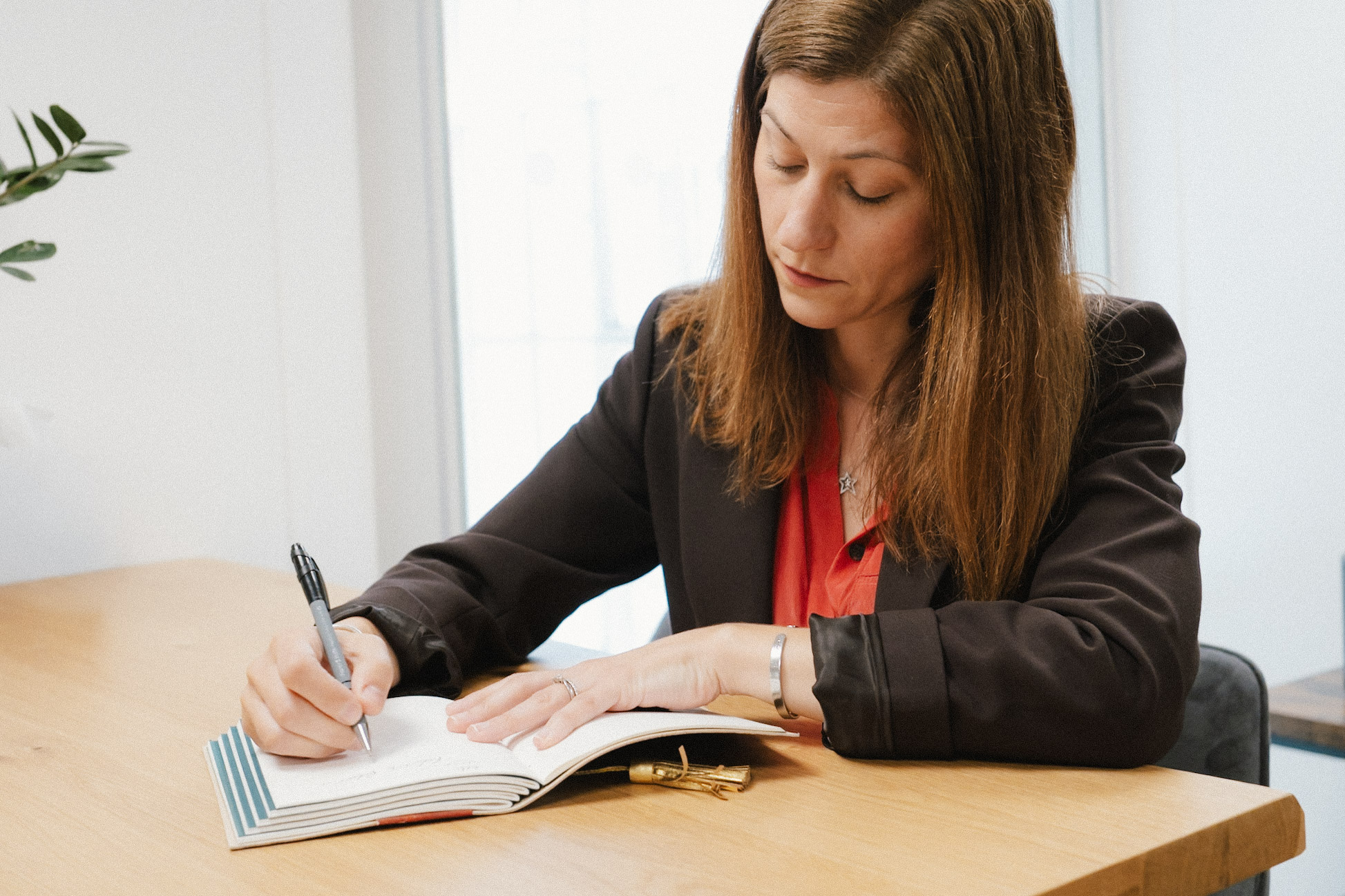 Rebecca Longman writing in a notebook